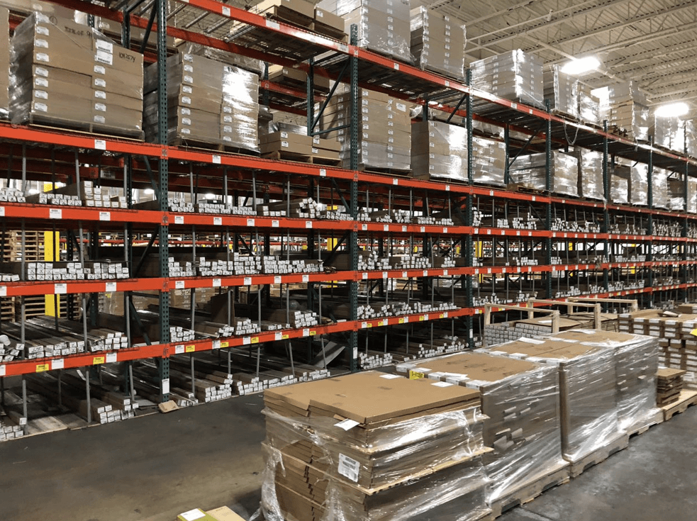 Orange warehouse racking system with material on the shelves