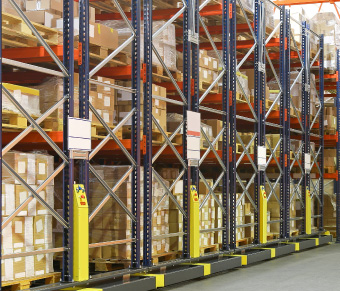 Tall racking in a warehouse containing pallets with boxes