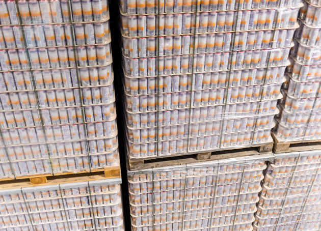 Tall stack of pallets containing canned beverages