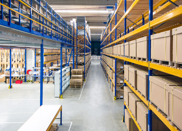 Large storage racking systems in warehouse storing pallets with boxes