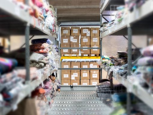 Folded clothing on storage racks in fulfillment warehouse