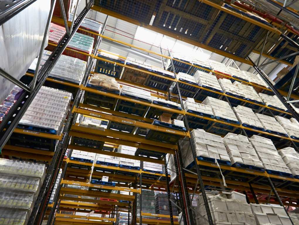 Multiple levels of storage racking in warehouse containing pallets of supplies